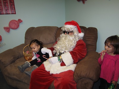 Santa posing with two children